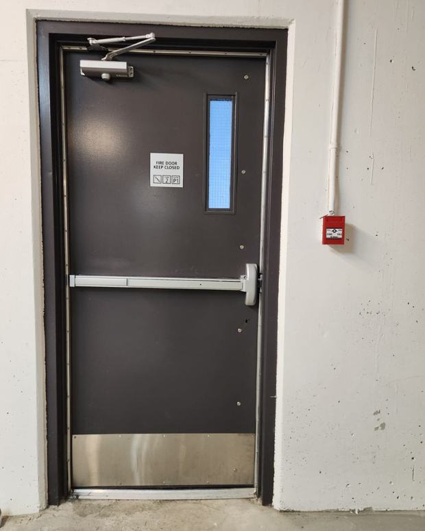 Panic bar and closer on a fire-rated commercial exit door