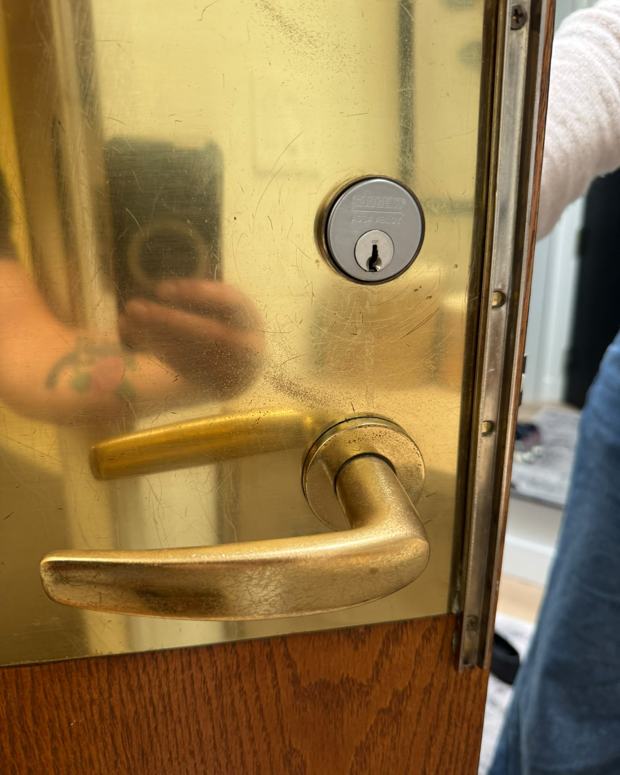 Brass mortise lock and lever handle on a condo entrance door