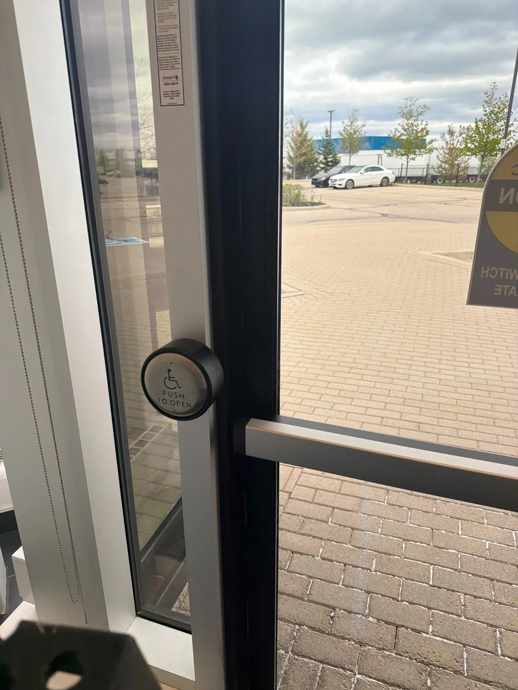 Automatic door with push-to-open actuator serviced by A+ Doors Inc in Vancouver