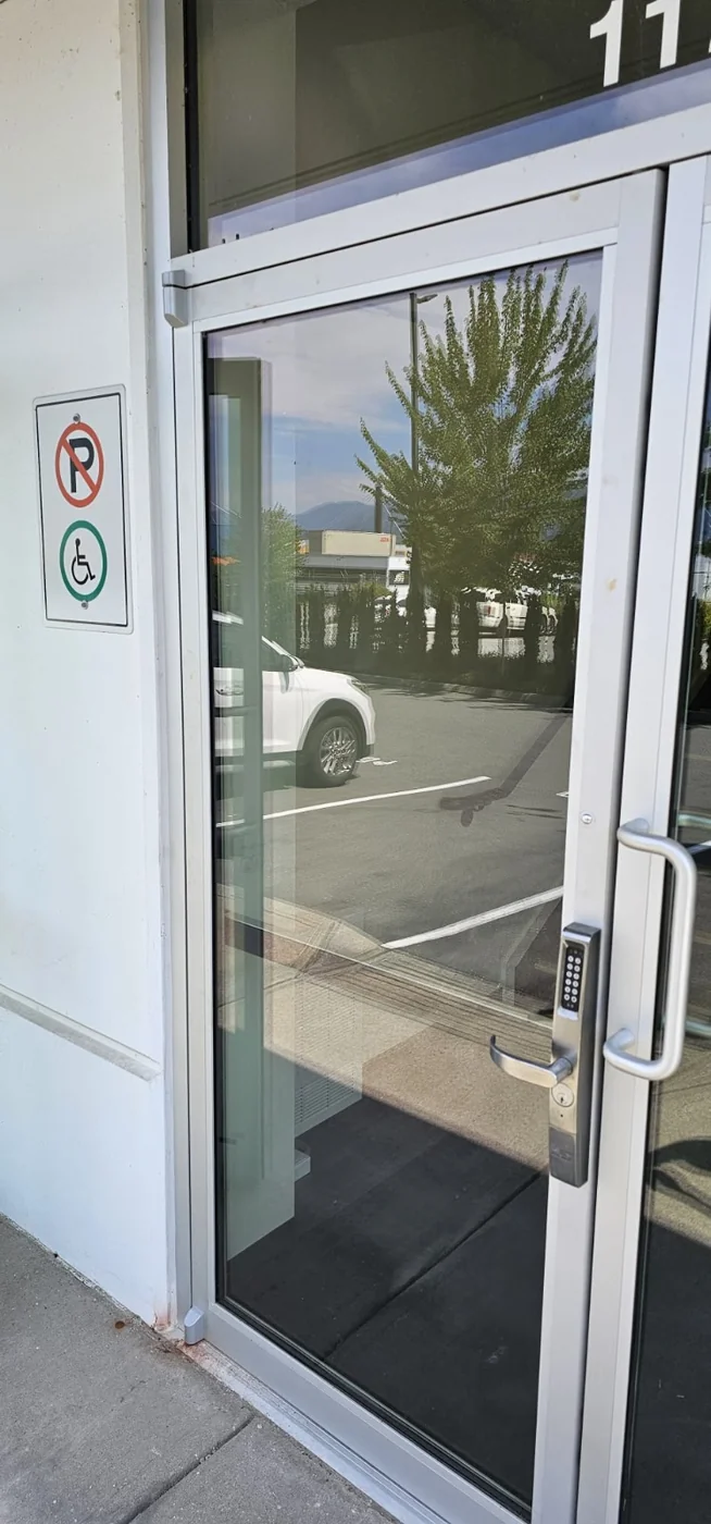 Commercial aluminum glass entry door with keypad access serviced by A+ Doors Inc